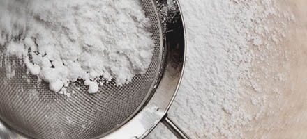 close up of powdered sugar in strainer